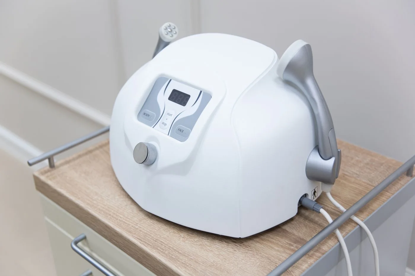 A professional facial treatment device on a cabinet